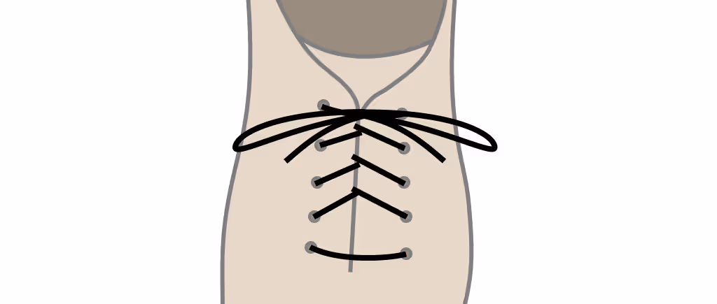 Black leather dress shoes with criss-cross lacing on a wooden surface